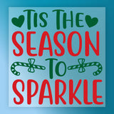 The "Tis the Season to Sparkle" precut sign by InkMerge features green and red text, two green hearts, candy canes with bows on a blue background—ready for your next heat press project!.