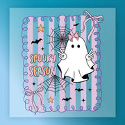 A spooky ghost character with a bow on its head, surrounded by Halloween-themed elements such as bats, stars, and a spider web. The text "SPOKEY SEASON" is displayed in the image.