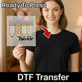 A woman holding a sign with a pencil graphic and the word "Teacher" written on it, with a red arrow pointing to the pencil graphic.