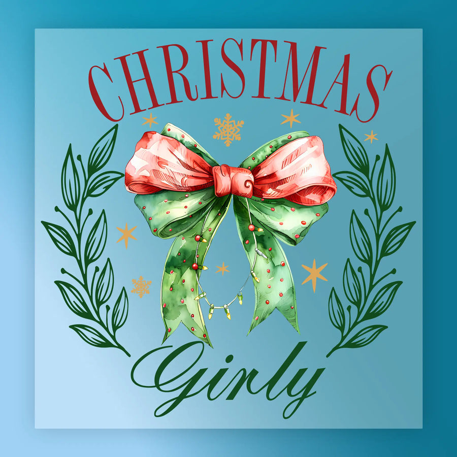 A festive InkMerge DTF transfer: "Christmas Girly with Bow and Laurel" features a pink and green bow, leafy branches, gold stars, and “CHRISTMAS Girly” text on blue—perfect for holiday projects.