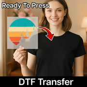 A smiling woman in a black shirt holds the InkMerge Retro Sunset Pixel Art Design, a colorful DTF transfer with forest art. "Ready To Press" and "DTF Transfer" text shows it’s heat press ready.