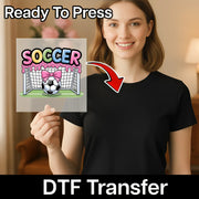 A smiling woman holding a sign with a soccer-themed graphic, and there is text indicating that the image is ready to be transferred using a DTF (Digital Transfer Function) transfer.