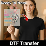 A woman holding a sign with a floral design and text, smiling at the camera.