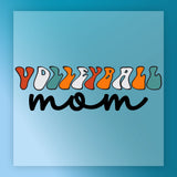 the text "Volleyball mom" in a stylized font, with the word "volleyball" written in a colorful, abstract design and " mom" written in a more traditional, cursive font.