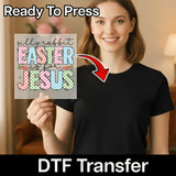 A woman is holding up a sign with the text "silly rabbit Easter is for Jesus" in front of her.