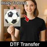 A woman holding a soccer ball in front of a sign that says "Ready To Press" and "DTF Transfer", indicating that the image is a digital transfer of a soccer ball image.