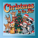 InkMerge's "Christmas In The Air Cartoon Animals" features cute animals in scarves and Santa hats decorating a tree, with the text "Christmas in the Air" above on blue—perfect for custom apparel or DTF transfer projects.