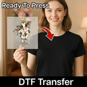 A smiling woman in a black shirt holds an InkMerge Funny Christmas Cow In Lights - Heat Press Ready DTF transfer, featuring festive decor and a star. “Ready To Press” text and a red arrow highlight this custom apparel sheet.
