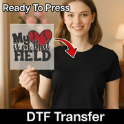 A woman holding a sign with the text "My heart is on that field" and a red arrow pointing to her chest.