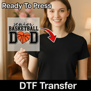 A smiling woman holding a sign with the text "Ready To Press senior basketball dad" and a basketball graphic.