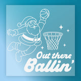 Santa Claus is shown jumping to dunk a basketball into a hoop, with the text "Out there Ballin'" below the illustration.