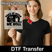 A smiling woman in a black t-shirt holds the InkMerge "This Is How We Roll Camper Design" DTF transfer—ready to press and perfect for custom apparel or your next heat press project.