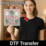 A woman is holding up a clear sticker with various cartoon-style illustrations, including cacti and Santa hats, and there is a red arrow pointing to the sticker.