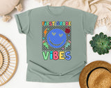 First Grade Vibes Checkered Smiley graphic tee in Bay