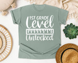 1st Grade Level Unlocked White graphic tee in Bay