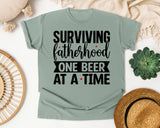 Surviving Fatherhood One Beer At A Time White graphic tee in Bay