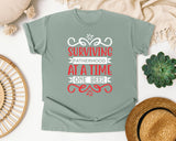 Surviving Fatherhood One Beer At A Time White 2 graphic tee in Bay