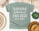 Surviving Fatherhood One Beer At A Time Classic graphic tee in Bay