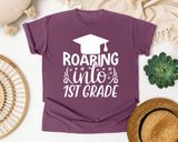 Roaring Into 1st Grade White 2 graphic tee in Berry