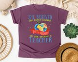 She Believed She Could Change The World So She Became A Teacher graphic tee in Berry