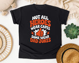 Not All Heroes Wear Capes Some Wear Dad Jokes Orange 2 graphic tee in Black