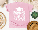 Roaring Into 1st Grade White 2 graphic tee in Blossom