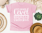 1st Grade Level Unlocked White graphic tee in Blossom