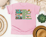 He Is Dad Brave Like David Warrior Like Joshua Teal graphic tee in Blossom