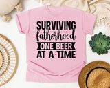 Surviving Fatherhood One Beer At A Time White graphic tee in Blossom