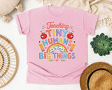 Teaching Tiny Humans To Do Big Things graphic tee in Blossom