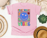 First Grade Vibes Checkered Smiley graphic tee in Blossom