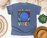 First Grade Vibes Checkered Smiley graphic tee in Blue Jean