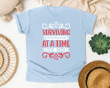 Surviving Fatherhood One Beer At A Time White 2 graphic tee in Chambray
