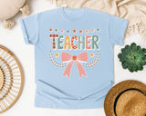 Teacher Bow Dotted Graphic Tee graphic tee in Chambray