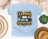 Learning Is My Superpower graphic tee in Chambray