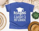 Roaring Into 1st Grade White 2 graphic tee in Flo Blue