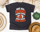Not All Heroes Wear Capes Some Wear Dad Jokes Orange 2 graphic tee in Graphite