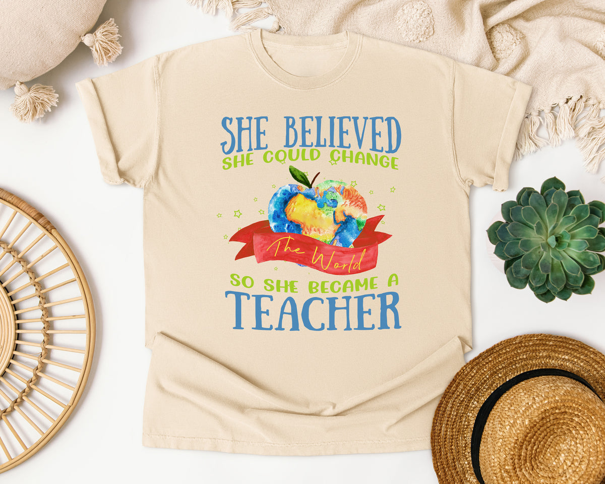 She Believed She Could Change The World So She Became A Teacher graphic tee in Ivory