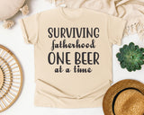 Surviving Fatherhood One Beer At A Time Grey 2 graphic tee in Ivory