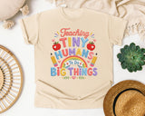 Teaching Tiny Humans To Do Big Things graphic tee in Ivory