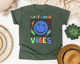 First Grade Vibes Checkered Smiley graphic tee in Moss