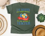 She Believed She Could Change The World So She Became A Teacher graphic tee in Moss