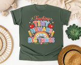 Teaching Tiny Humans To Do Big Things graphic tee in Moss