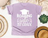 Roaring Into 1st Grade White 2 graphic tee in Orchid