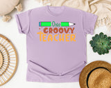 One Groovy Teacher graphic tee in Orchid