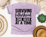Surviving Fatherhood One Beer At A Time White graphic tee in Orchid