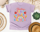 Teaching Tiny Humans To Do Big Things graphic tee in Orchid