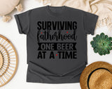 Surviving Fatherhood One Beer At A Time White graphic tee in Pepper