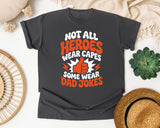 Not All Heroes Wear Capes Some Wear Dad Jokes Orange 2 graphic tee in Pepper