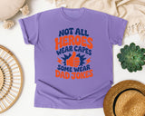 Not All Heroes Wear Capes Some Wear Dad Jokes Orange graphic tee in Violet